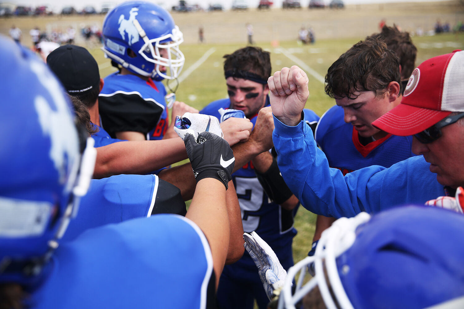 Kaycee’s football team puts their hands together in the huddle